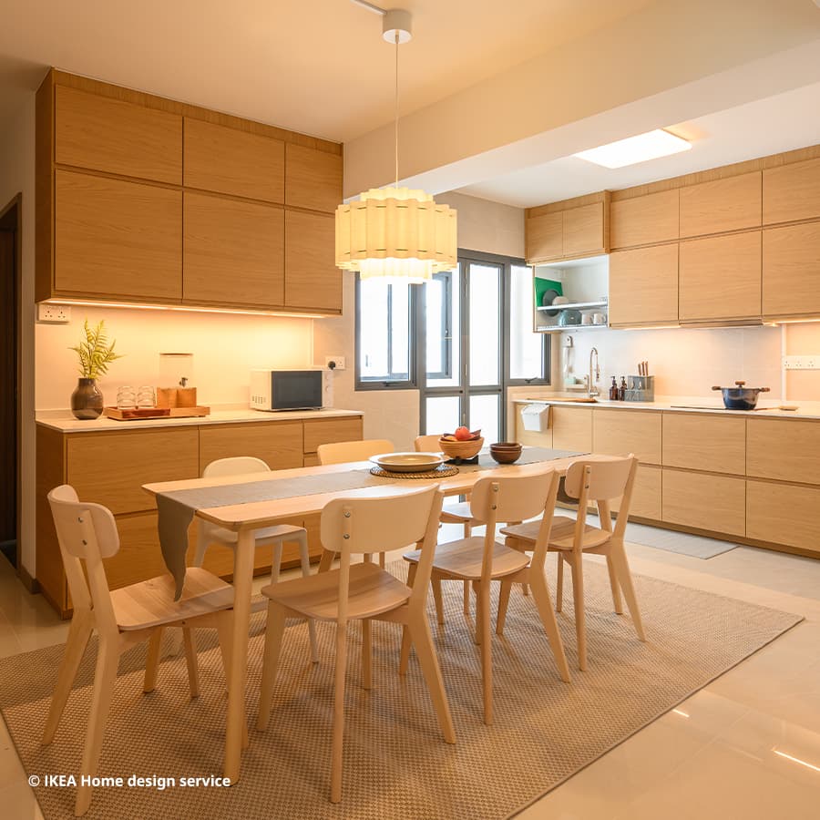 A wide shot of a combined kitchen and dining area from a Japandi/ Scandinavian-inspired 4-room BTO flat in Bidadari, Singapore, designed by IKEA Home design service.