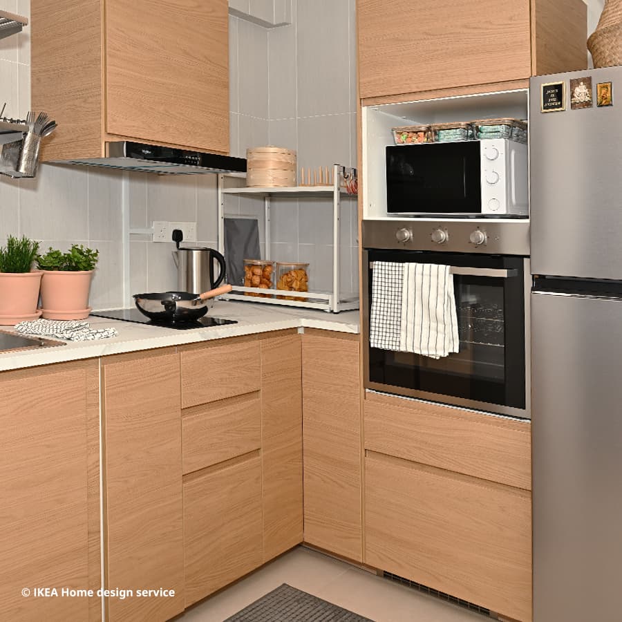 A wide shot of a kitchen from a Scandinavian modern 2-room flexi BTO flat in Toa Payoh, Singapore, designed by IKEA Home design service.