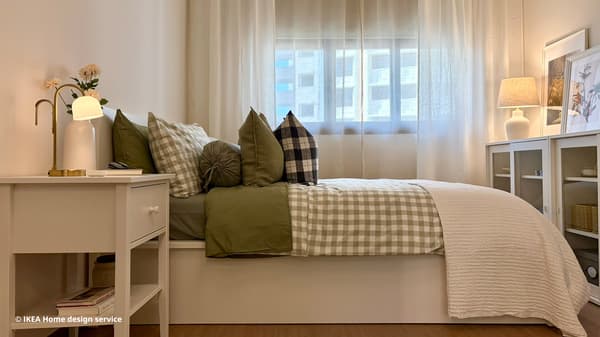 A wide shot of a master bedroom featuring a white MALM ottoman bed from a traditional modern 4-room BTO flat in MacPherson, Singapore, designed by IKEA Home design service.