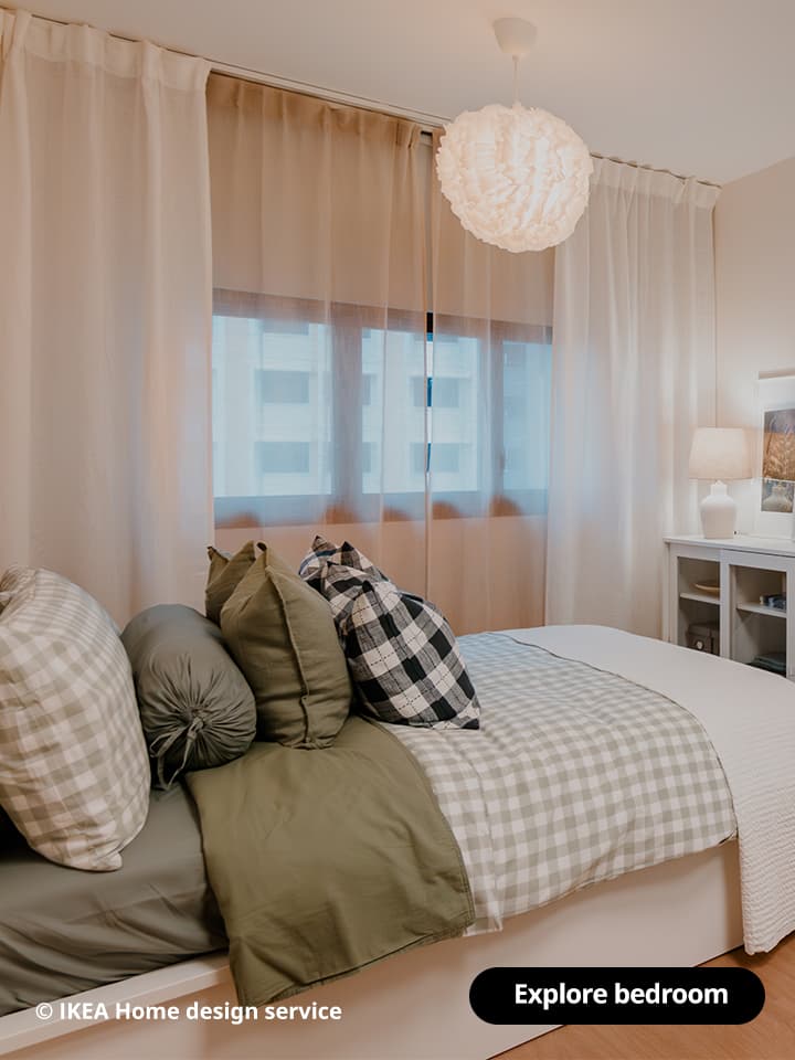 A wide shot of a master bedroom featuring a white MALM ottoman bed from a traditional modern 4-room BTO flat in MacPherson, Singapore, designed by IKEA Home design service.