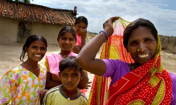 A woman and young children in a rural village in India