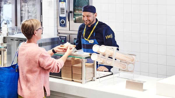 A woman being served a snack at the IKEA Swedish bistro.