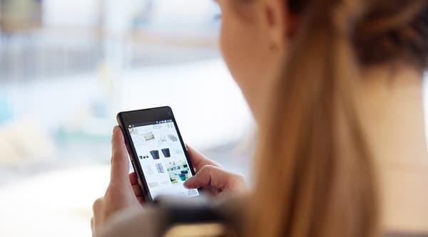 A woman browsing the IKEA website on a mobile device.