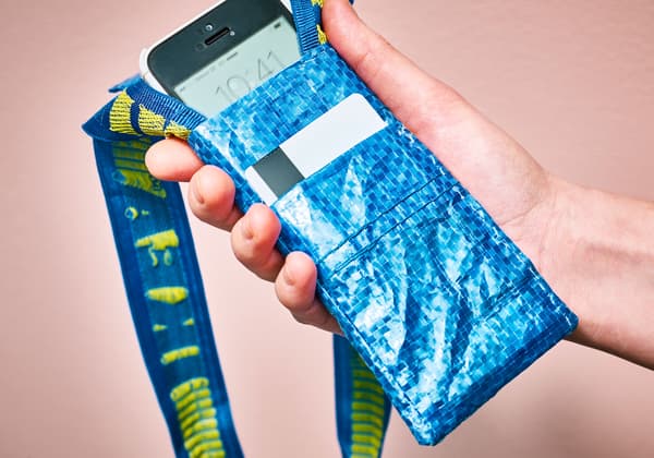 A woman checks the time on her phone in a phone pouch.