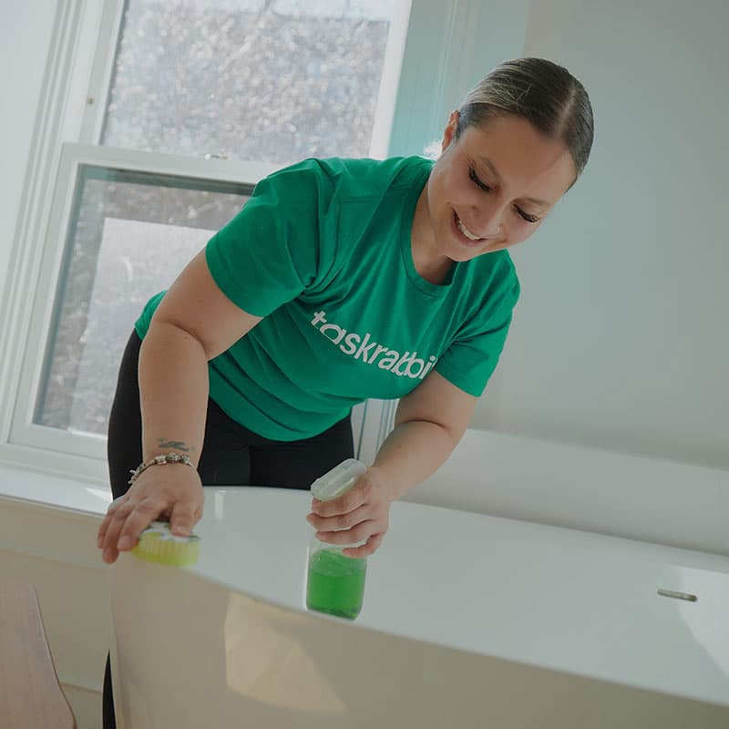 A woman cleaning a bath tub