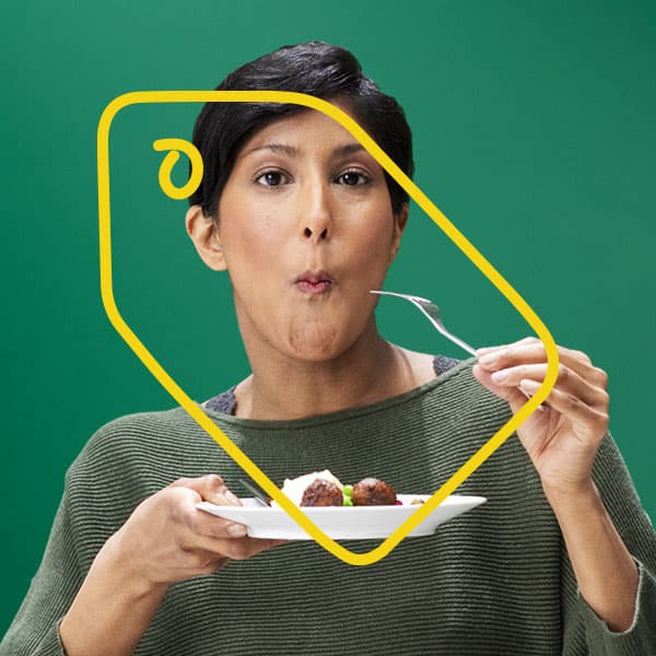 A woman eating meatballs.