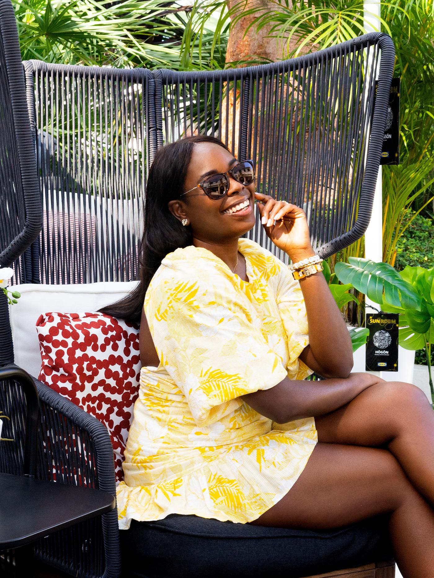 A woman in a yellow dress smiling 