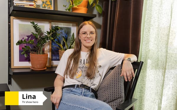 A woman is sitting on a chair in a bedroom, smiling, with framed artwork and plants behind her. Text in the bottom-left corner reads: “Lina, TV show hero”.
