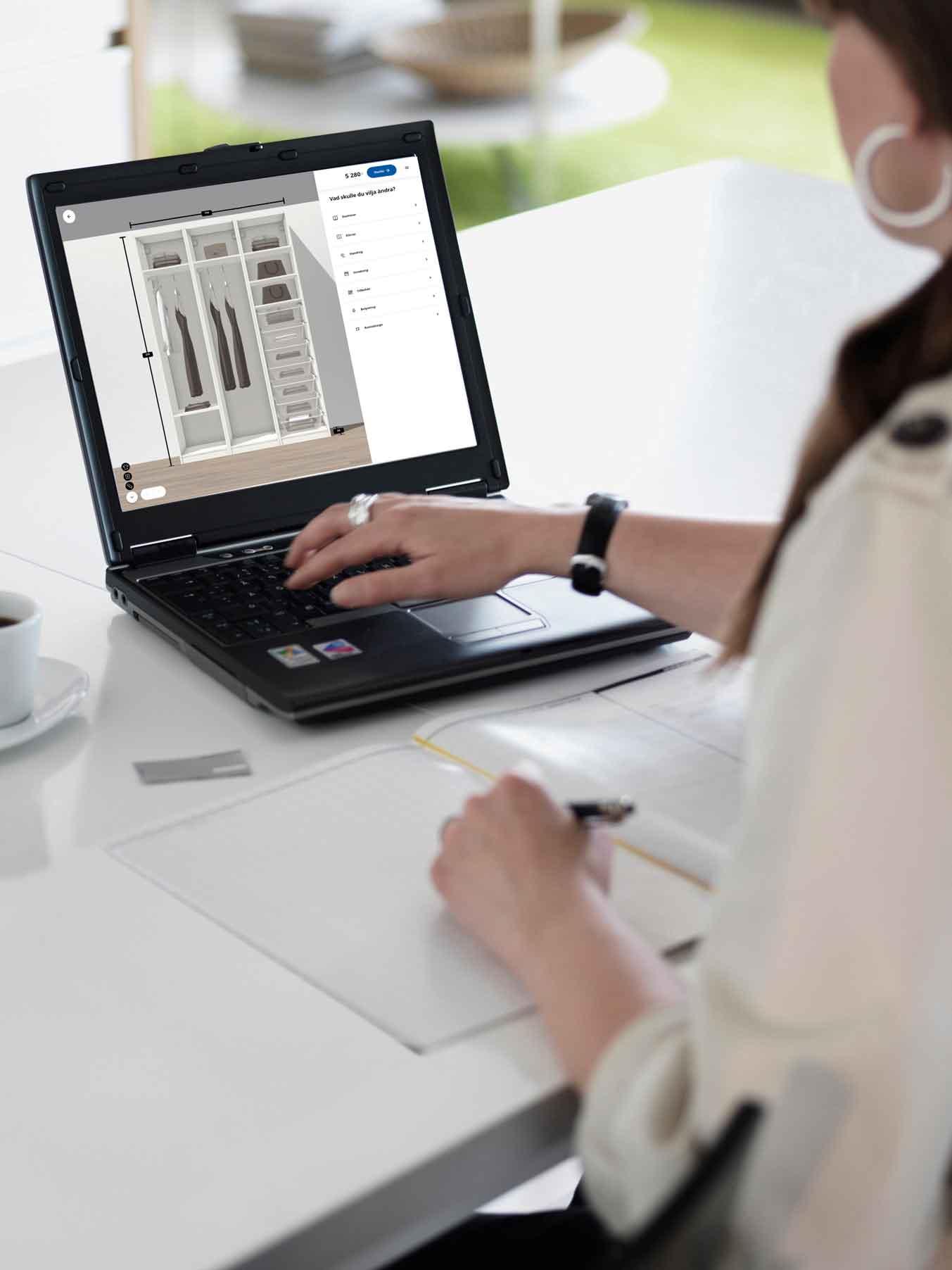 A woman planning a wardrobe solution on her laptop