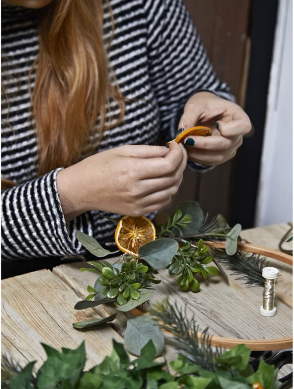 A woman sitting at a table crafting.