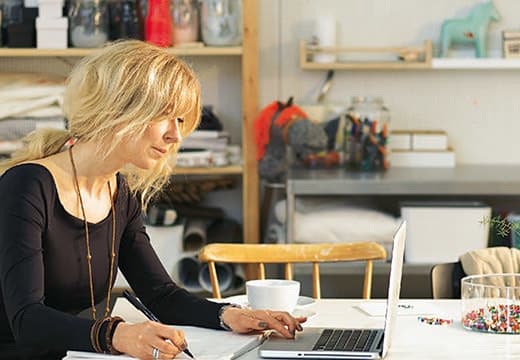 A woman sitting in front of a laptop computer.