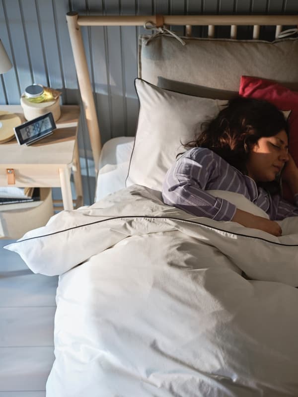 A woman sleeping facing the opposite side of the window