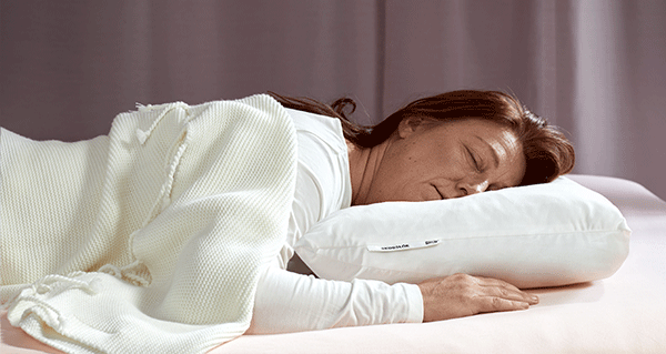 A woman sleeps on her stomach, stomach sleeper