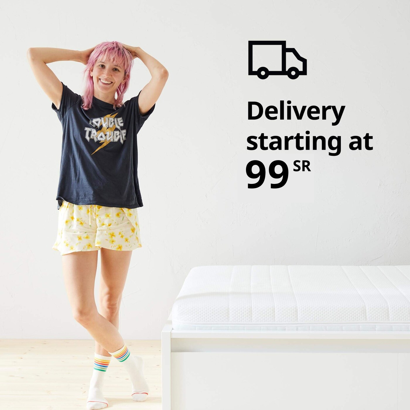 A woman standing in her pajamas next to a bed and a delivery truck symbol and the text 'Delivery starting at $19' on the image.