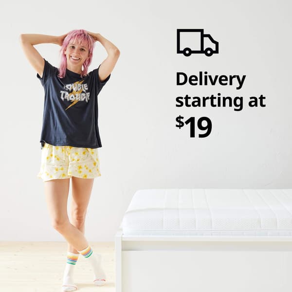 A woman standing in her pajamas next to a bed and a delivery truck symbol and the text 'Delivery starting at $19' on the image.