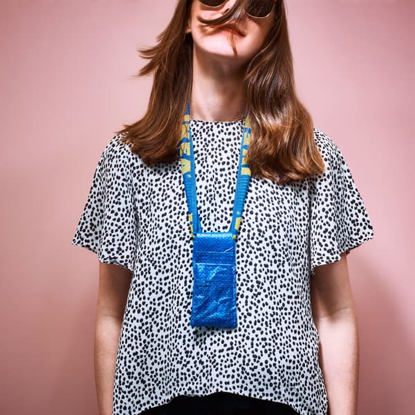 A woman wears a homemade phone pouch.