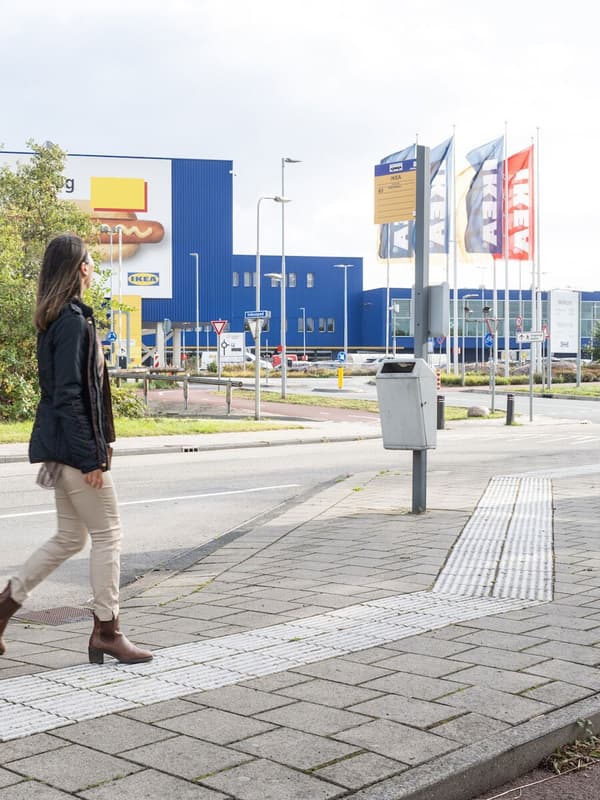 A women walking on the street and looking at the IKEA store