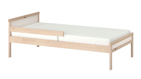 A wooden junior bed frame with a red circle singling out the bed rail.