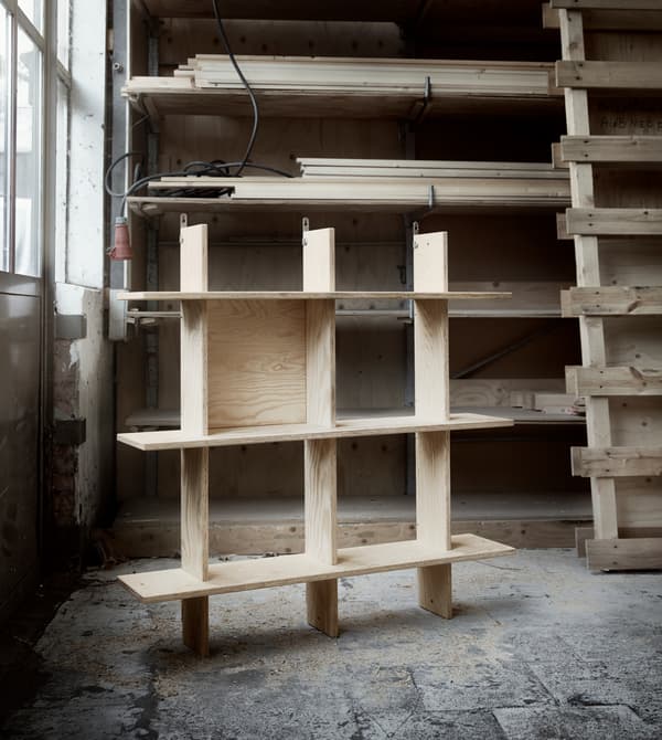 A wooden shelving unit in a workshop.