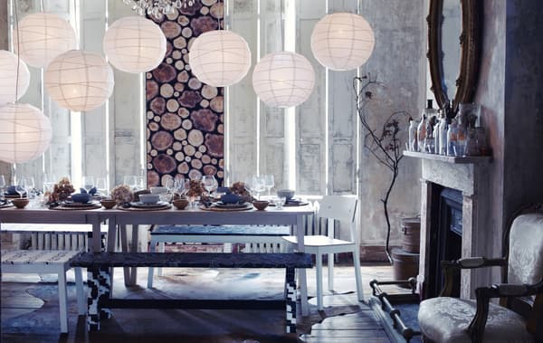 A woodland-style dining room with snowy lanterns and a table covered in seasonal decoration
