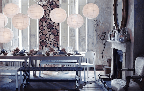 A woodland-style dining room with snowy lanterns and a table covered in seasonal decoration
