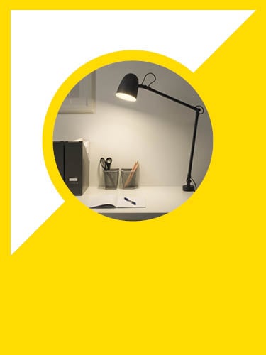 a work lamp shining down onto a desktop