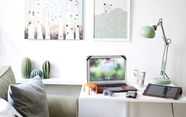 A workspace next to a sofa. 