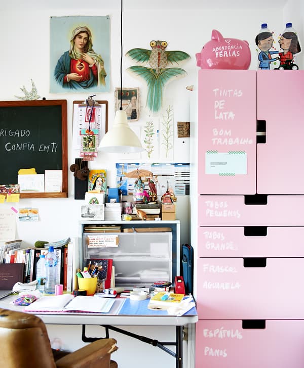 A workspace with pink storage unit.