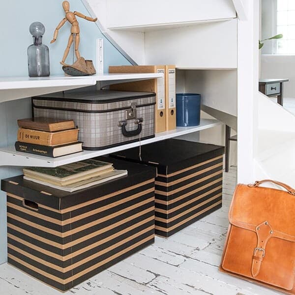 A workspace with striped paper boxes on the ground holding personal stuff.