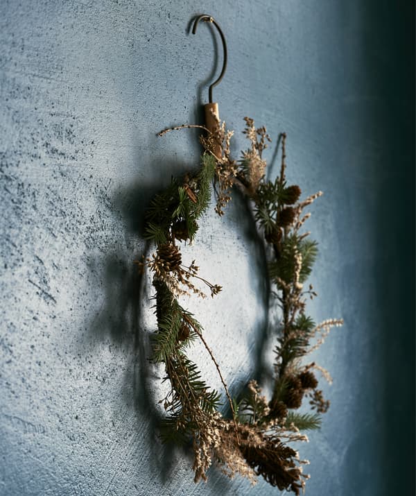 A wreath of flowers in front of a blue wall