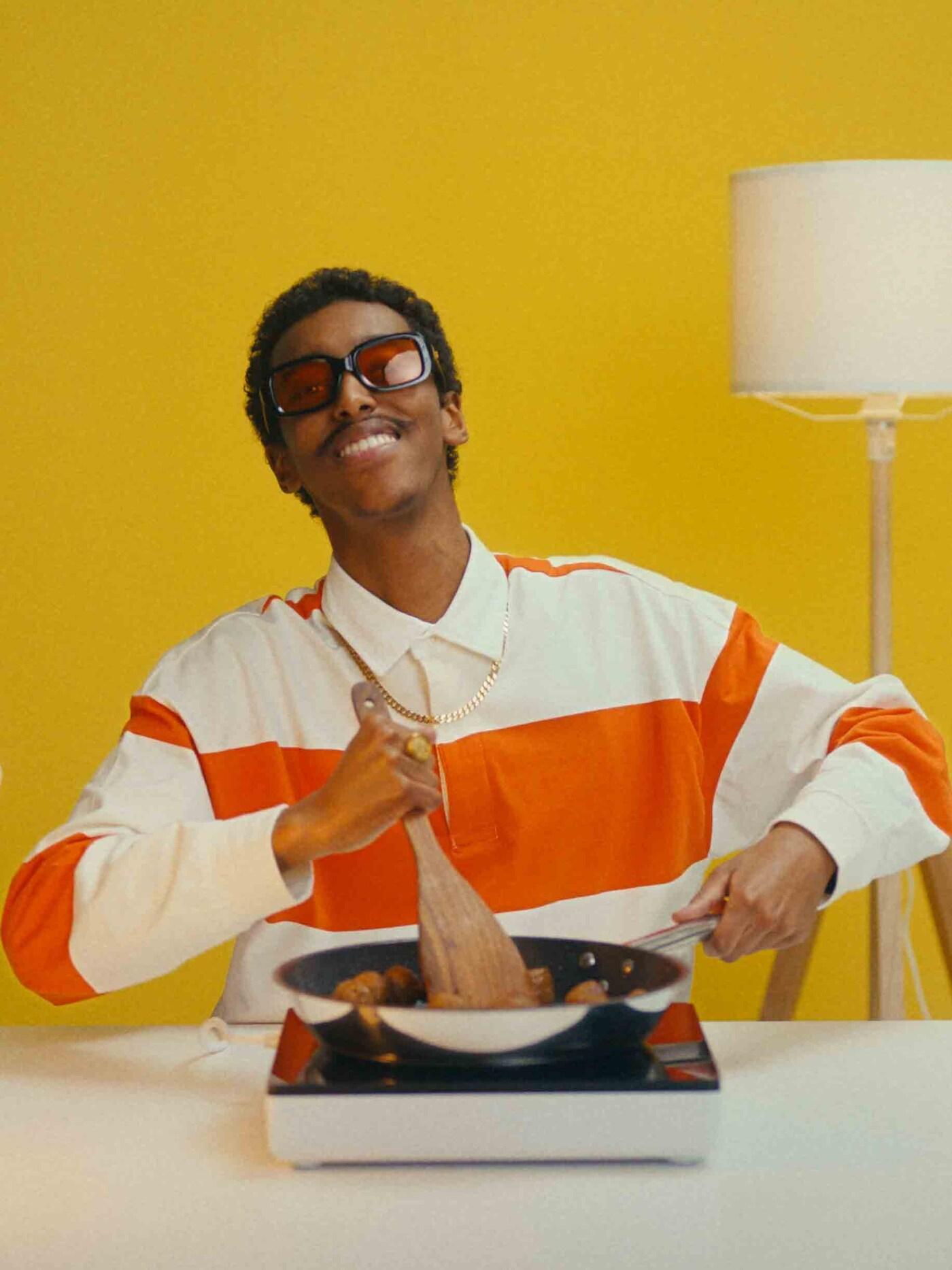 A yong man with a frying pan 