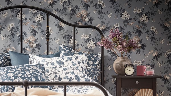 SAGSTUA bed frame with floral bedding linking to the bedrooms page. 