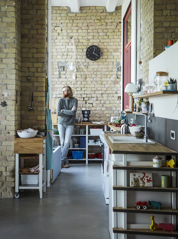 Adam standing in the kitchen with open storage.