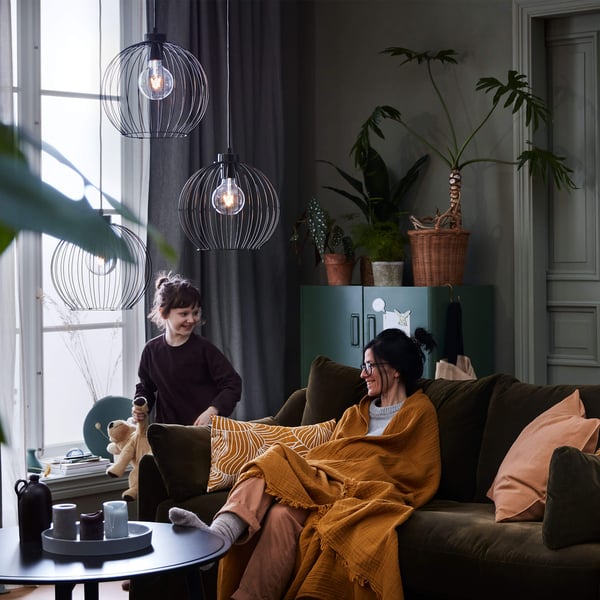 Adult and child on a sofa in a cozy modern living room