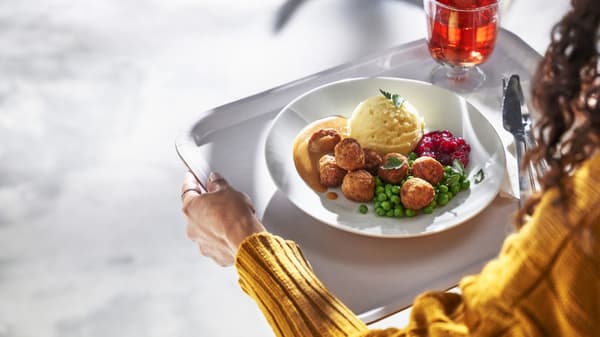 Adult Entree Chicken Balls, Mashed Potatoes, Peas, Lingonberry Sauce, on food tray with drink
