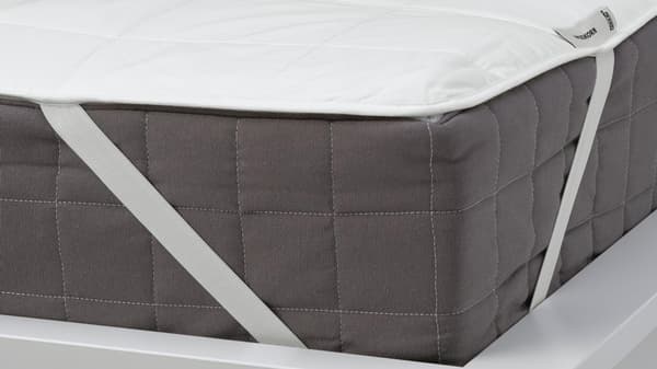 ÄNGSKORN mattress protector with elastic ribbon sides.