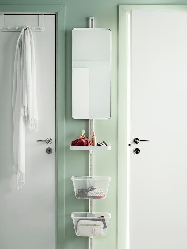 ALGOT storage system hung vertically on a small section of wall between two doors. It includes a mirror, shelf and baskets.
