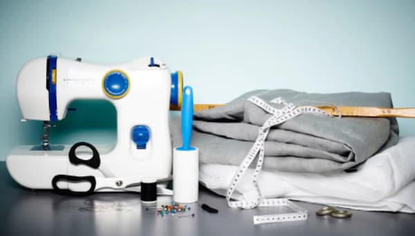 All you need to sew a soundproof curtain, including an IKEA sewing machine, fabric, measuring tape,, pins, scissors and cotton thread