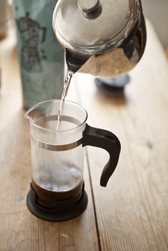 Allow the coffee to bloom with a little hot water