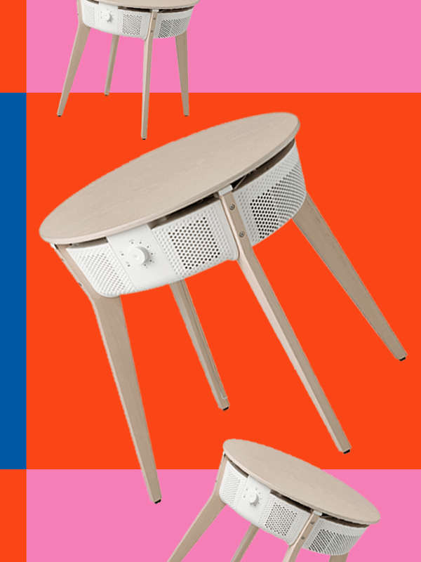 An air purifier floating against a colorful red and pink background with blue highlight.