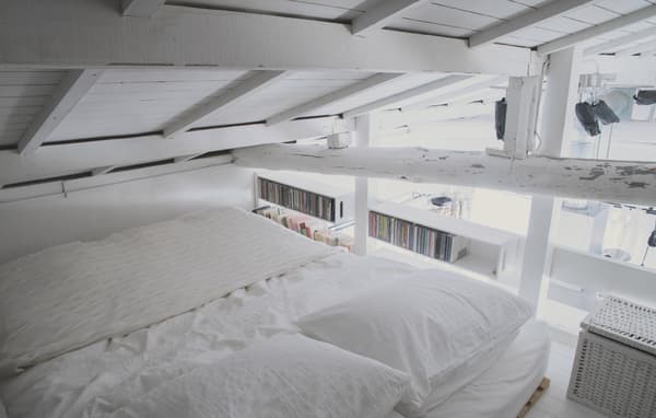 An all-white loft bedroom in a small Tokyo home.