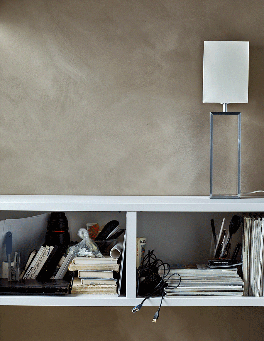 An animated gif of a closed-door cabinet being filled and decorative objects being placed on top.