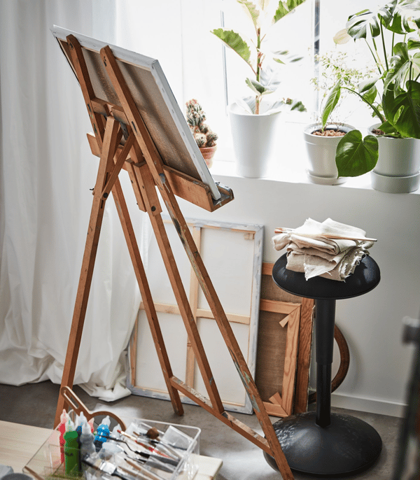 An easel beside a desk.