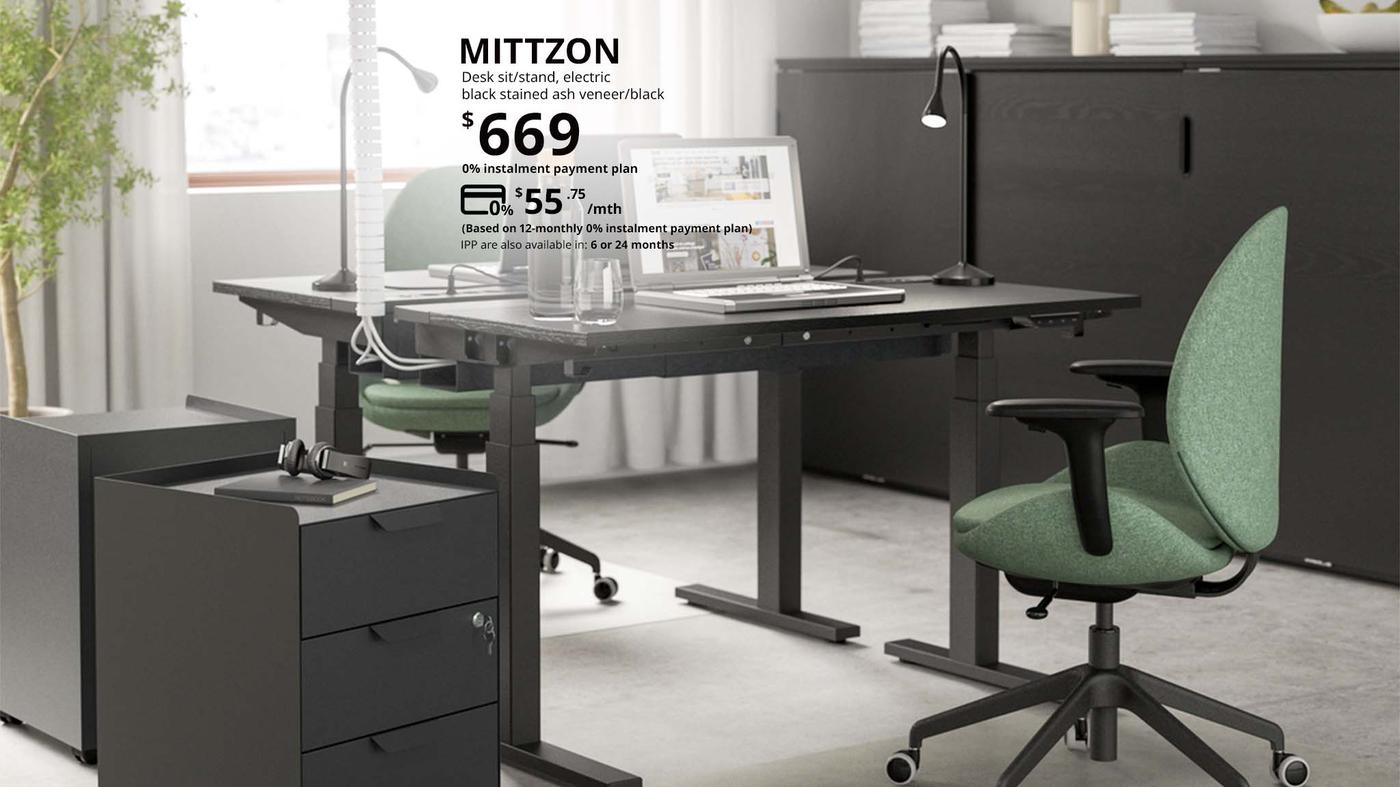 An electric MITTZON sit/stand desk, in an office setting, priced at $669 but now can be paid at $55.75 per month for 12 months under a 0% instalment payment plan