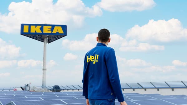 An employee inspects the rooftop solar panels