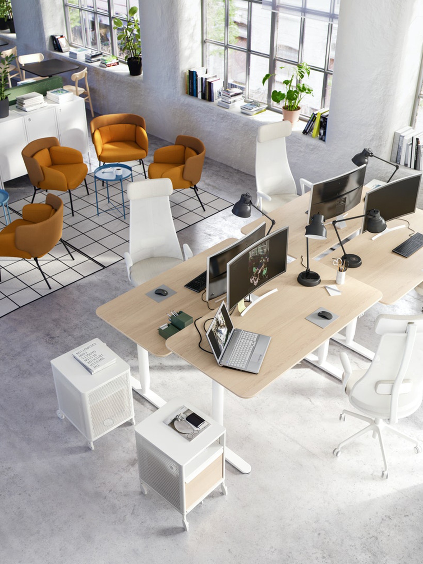 An empty office showing a long table with computer monitors.