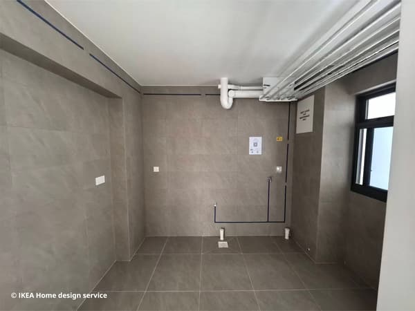 An empty pre-renovated kitchen space in a 3-room BTO flat in Singapore, owned by a retired couple.