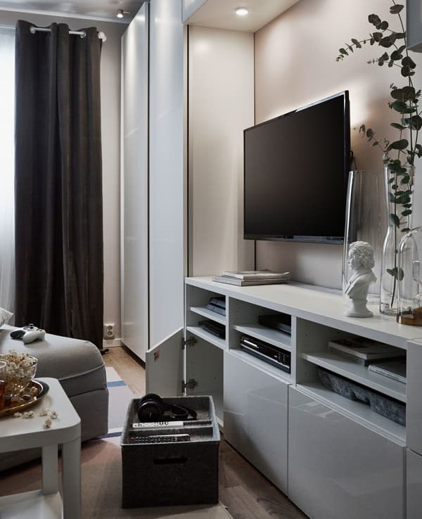 An entertainment centre set up with open and closed storage, interior organisers and a large grey TV bench.