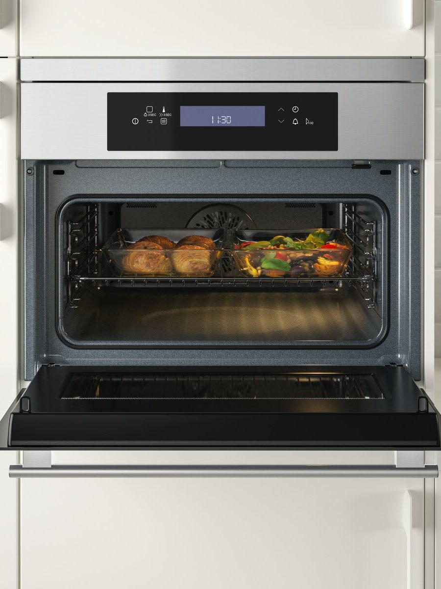 An IKEA 700 KULINARISK microwave combi with forced air in a white kitchen cabinet.