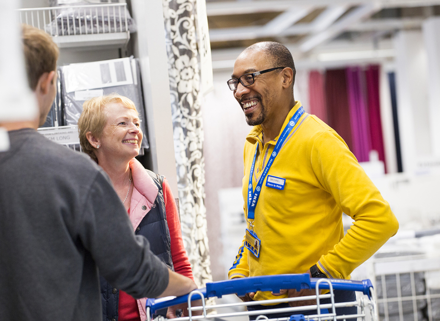 An IKEA co-worker helping customers in-store